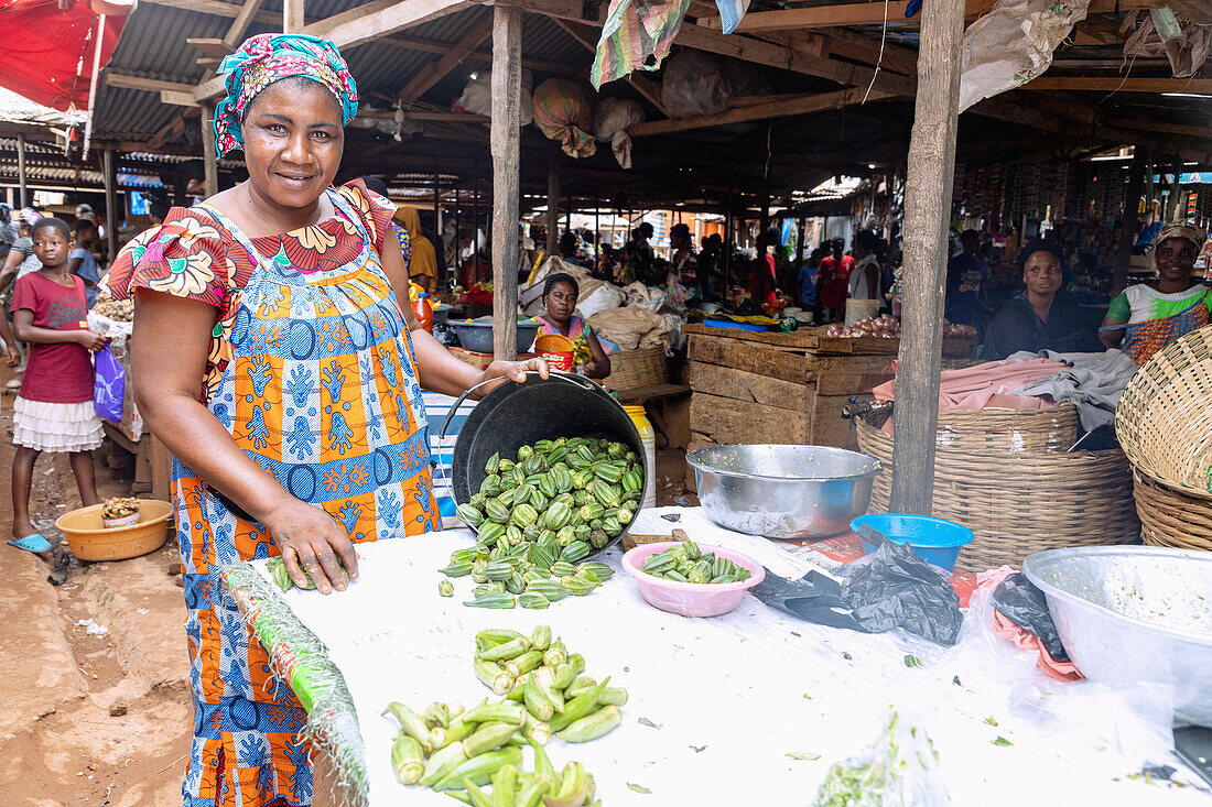 Selling okra at the weekly market in Techiman in the Bono East region of central Ghana in West Africa