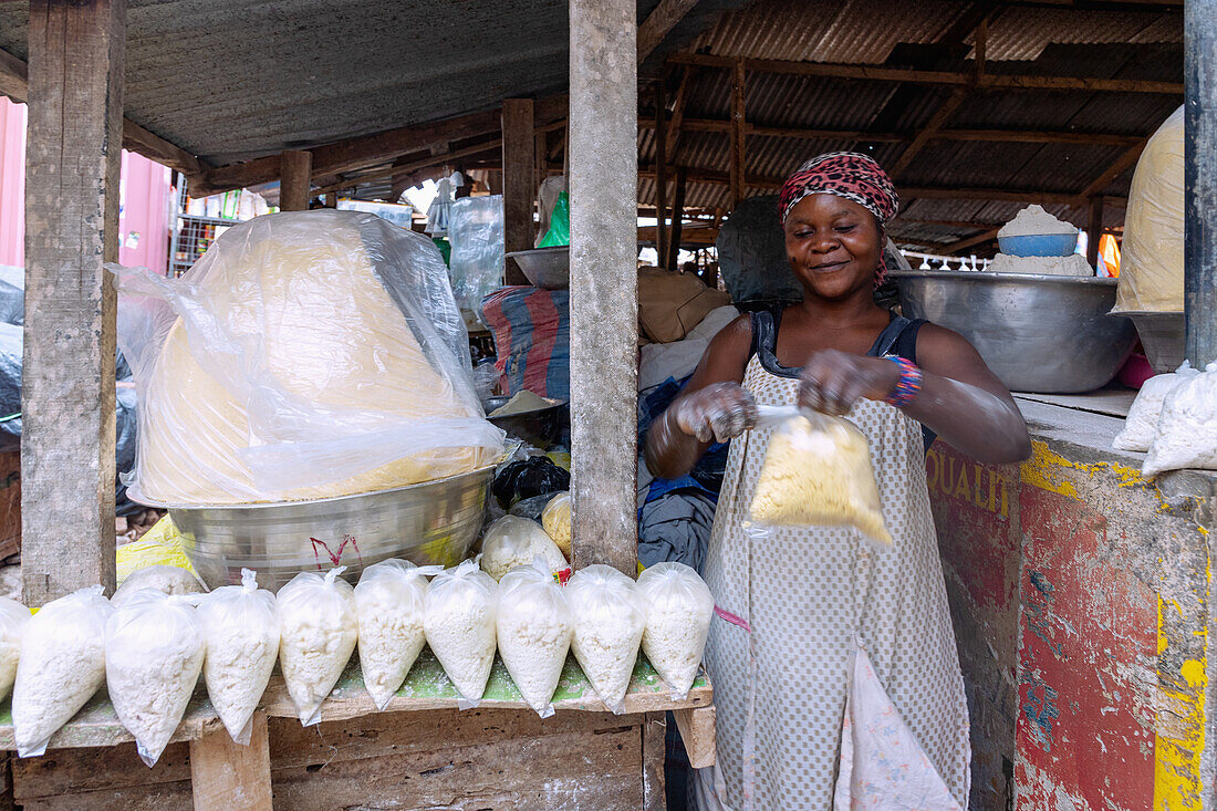 Selling cassava flour and tapioca at the weekly market in Techiman in the Bono East region of central Ghana in West Africa