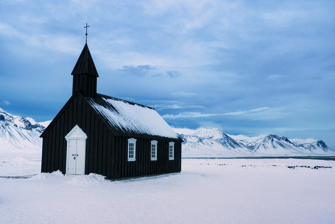 The Church of Budir on a stormy winter evening, Iceland.