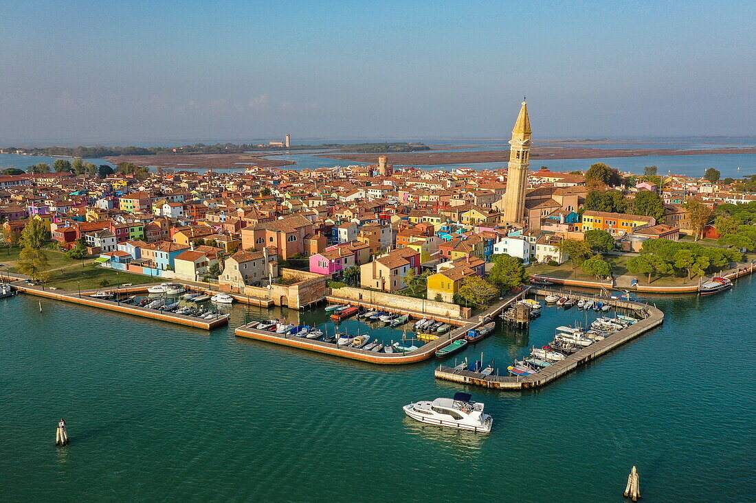 Aerial view of Houseboat Italia Minuetto 8 electric houseboat and Burano with its colorful houses, Burano, Venice, Italy, Europe