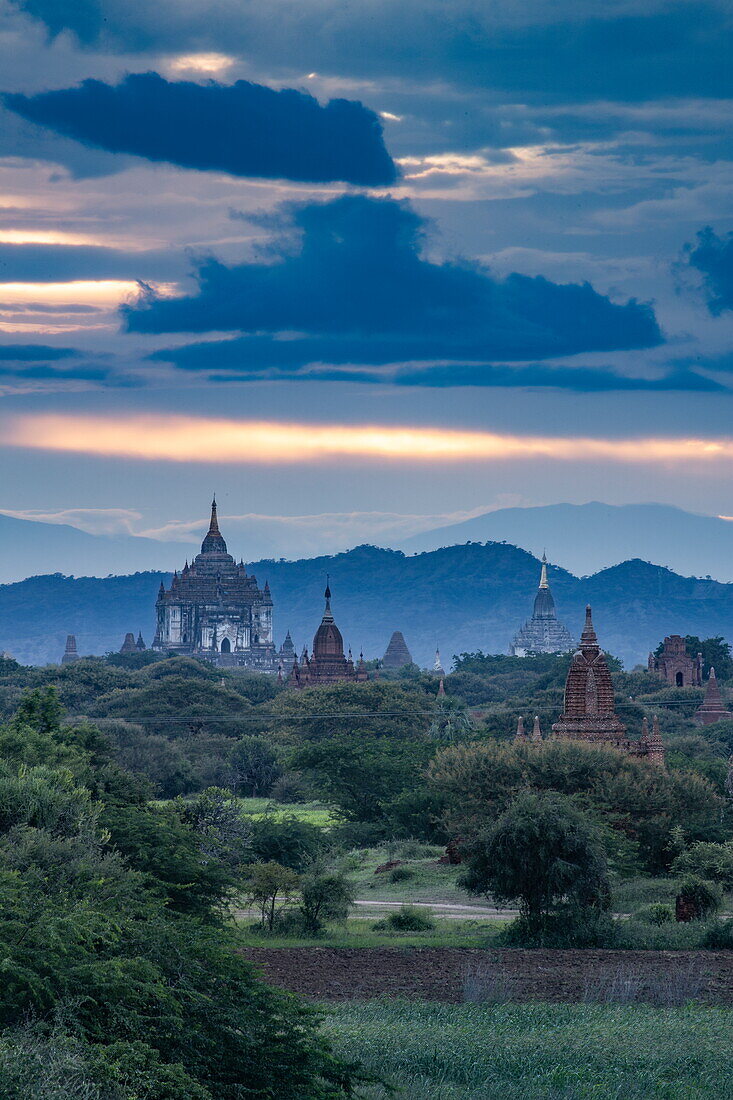 Ancient stupas with storm clouds in the distance, Old Bagan, Nyaung-U, Mandalay Region, Myanmar, Asia