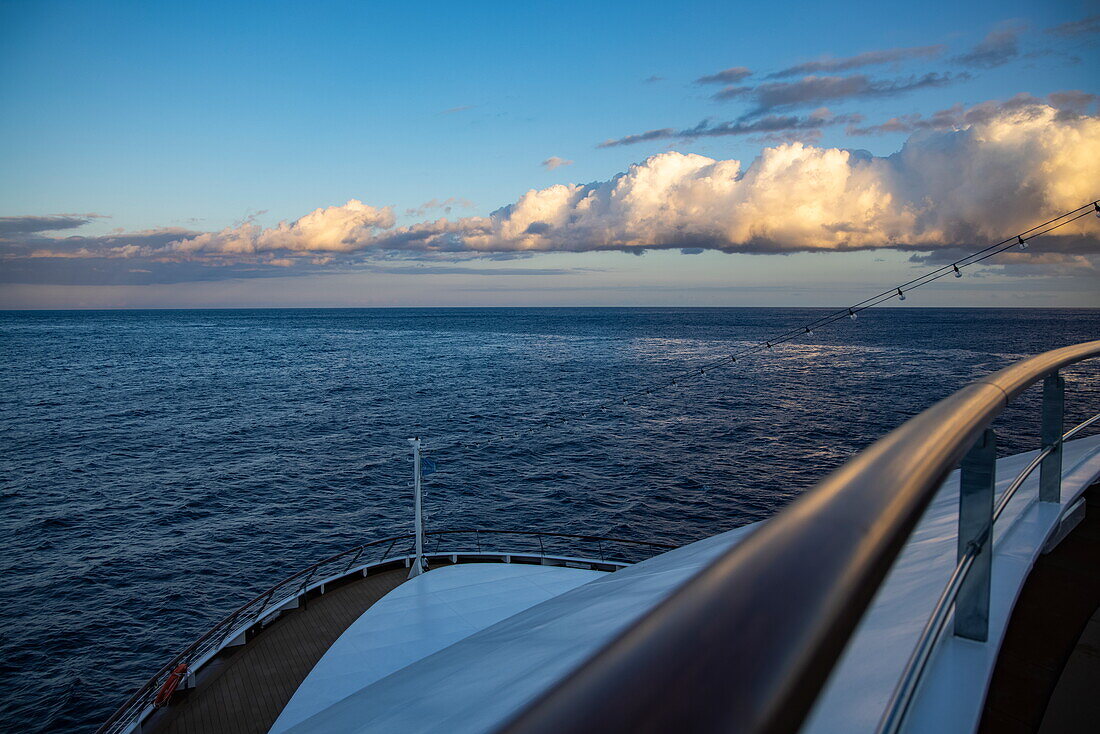 Deck railings and bow of expedition cruise ship World Voyager (Nicko Cruises) with late afternoon clouds, at sea, near La Gomera, Canary Islands, Spain, Europe