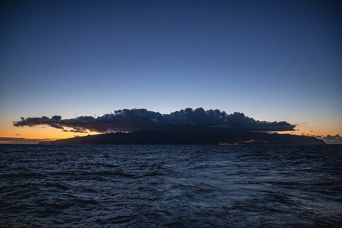 Silhouette of La Gomera with cloud at dusk, at sea, near La Gomera, Canary Islands, Spain, Europe