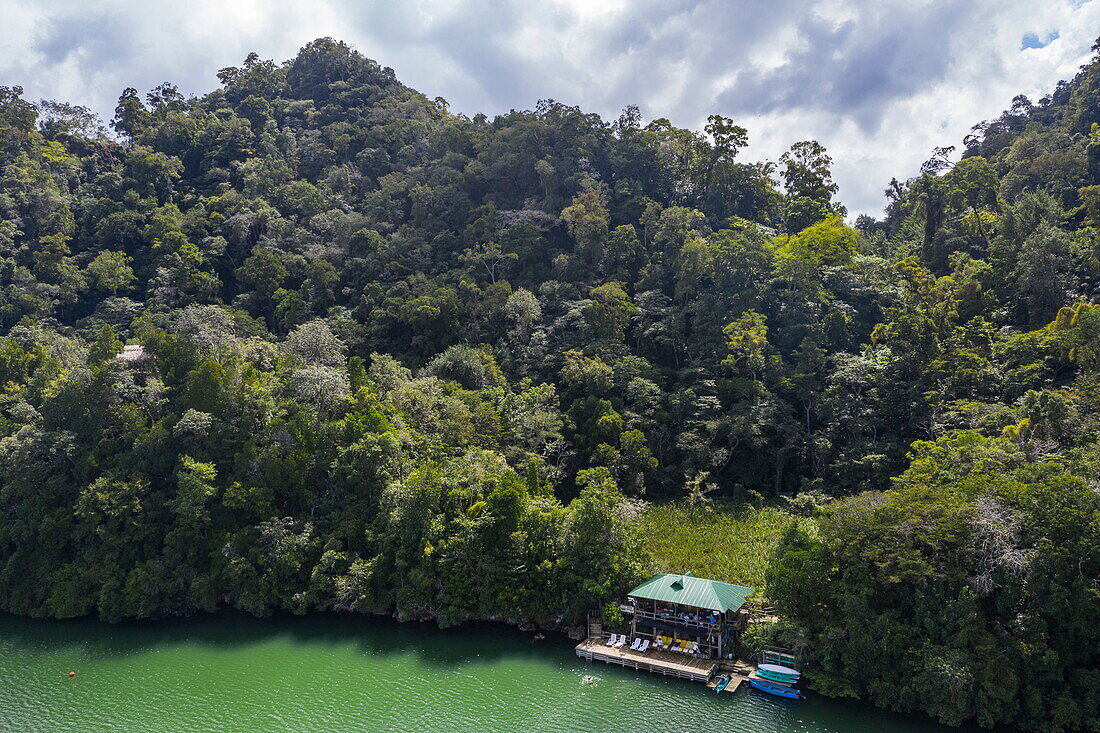 Aerial view of park restaurant in Ensenada Verde Bay with rainforest, near Santo Tomás de Castilla, Izabal, Guatemala, Central America