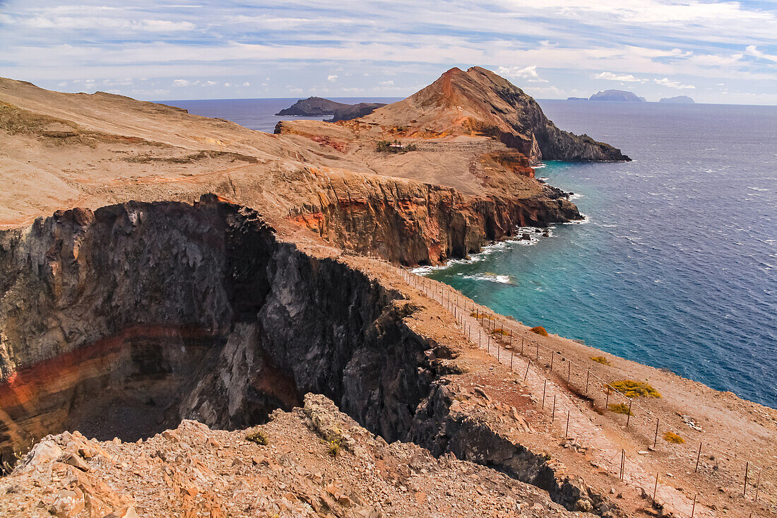 An adventurous hiking trail runs along a ridge between the sea past São Lourenço Bay, Madeira Island, Portugal