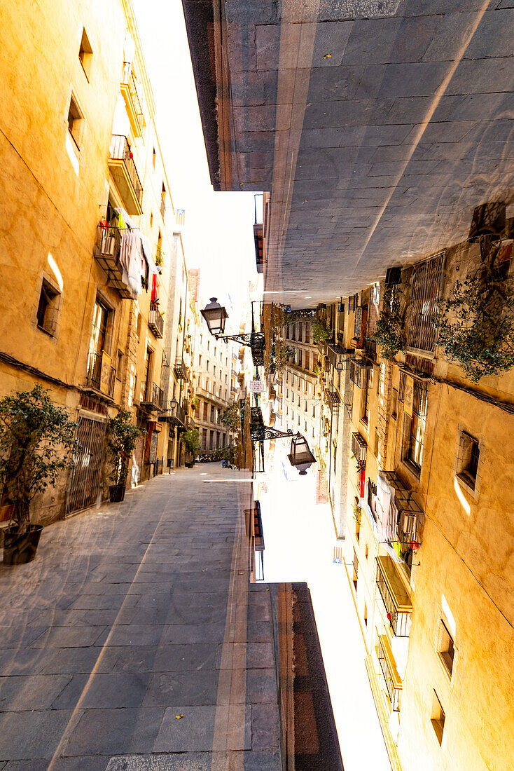 Double exposure view of one of Barcelona's typical stone paved downtown streets.