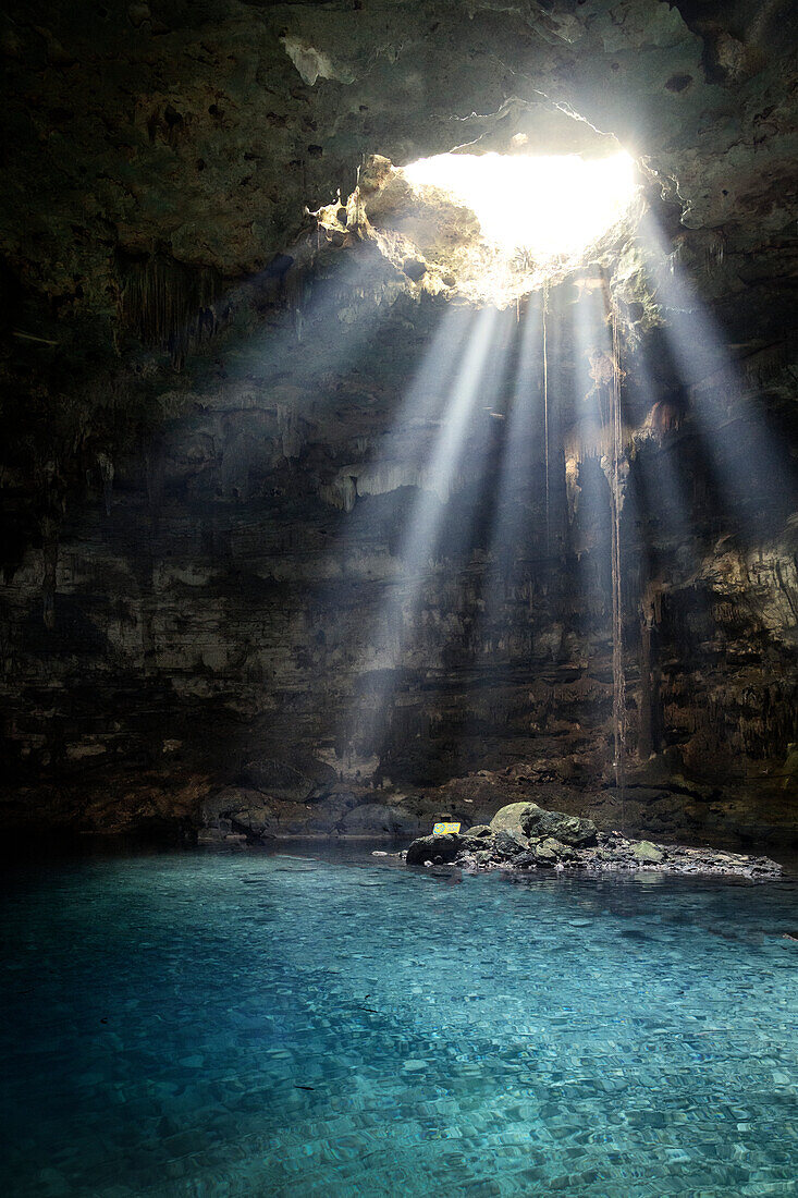 Sunbeams enter Cenote Xkeken near Valladolid through a hole in the rock ceiling, Yucatan, Mexico, North America, Latin America