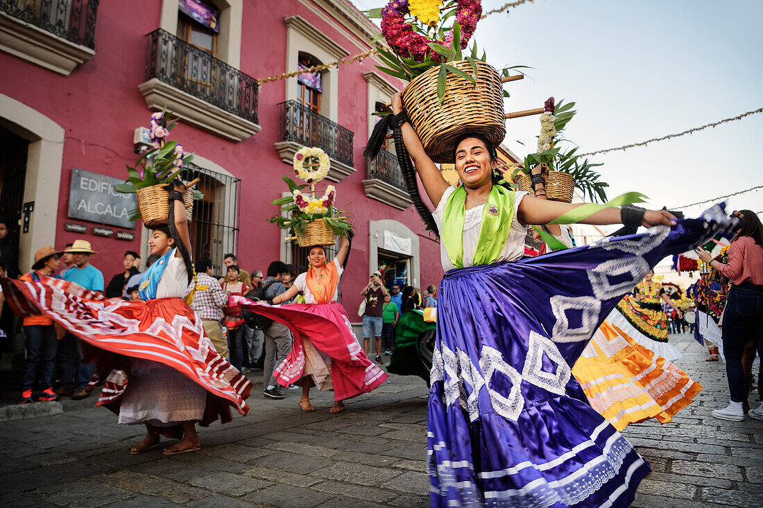 Women with skirts (traditionally dressed indigenous people) dance through the old town of Oaxaca de Juárez, Oaxaca State, Mexico, North America, Latin America