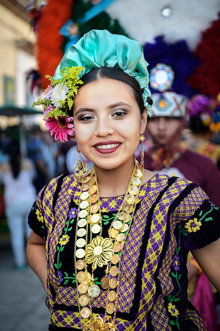 young woman in traditional costume smiling at the camera, city of Oaxaca de Juárez, Oaxaca State, Mexico, North America, Latin America