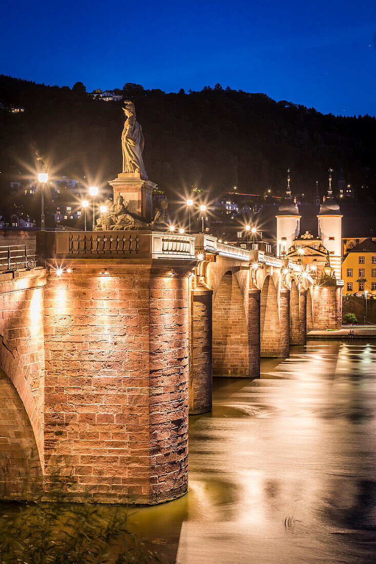 Old Neckar Bridge with a view of Heidelberg Castle and Old Town in the evening, Baden-Württemberg, Germany
