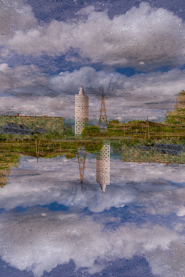 Double exposure of a column shaped modern building next to a power line tower in Tartu, Estonia.