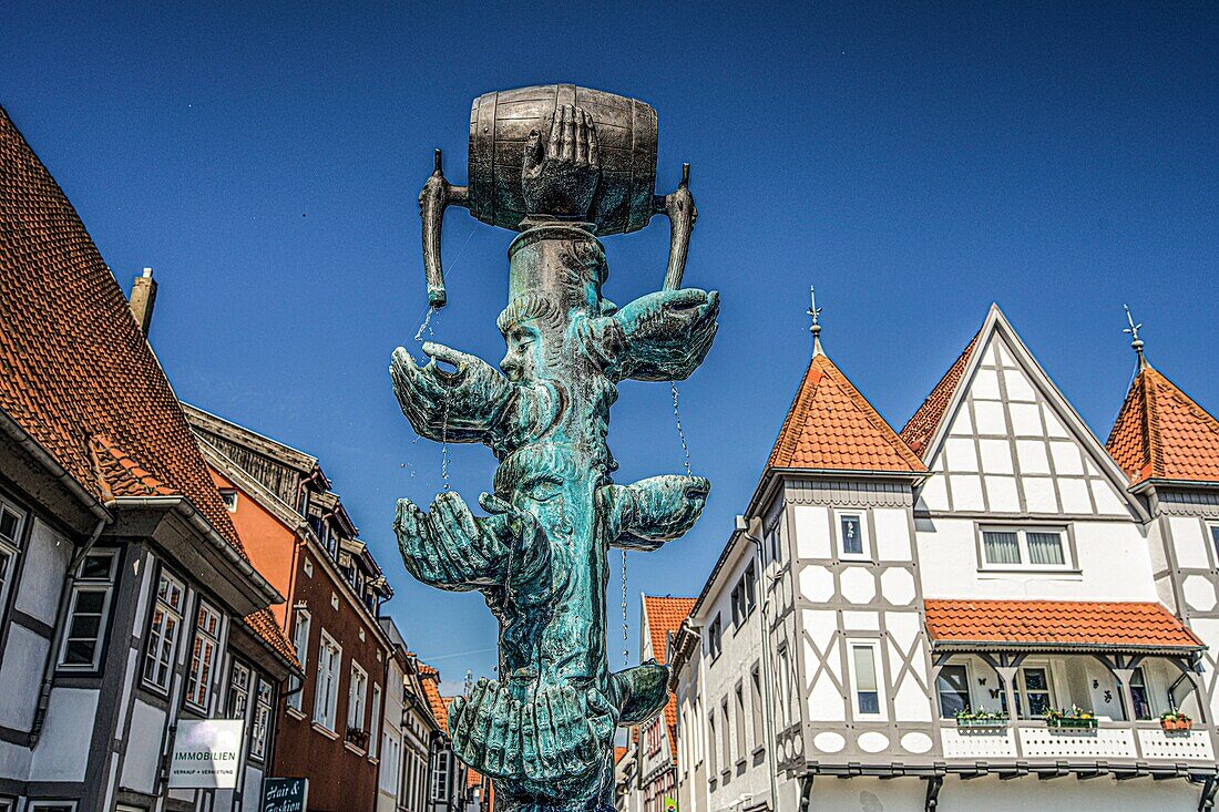 Chancellor's fountain by Bonifatius Stirnberg from 1977 at the Ostertor and view of half-timbered houses in front of Mittelstraße, old town of Lemgo, North Rhine-Westphalia, Germany
