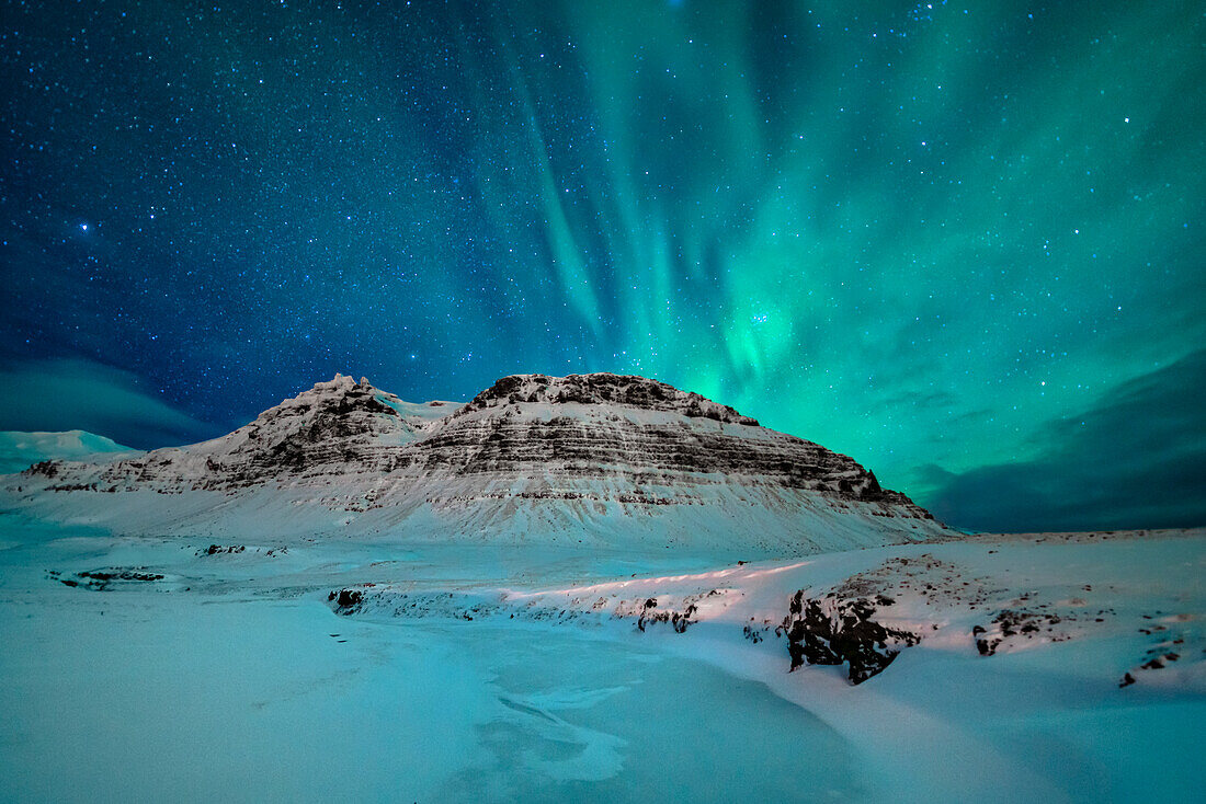 Aurora Borealis over Icelandic mountains, Iceland.