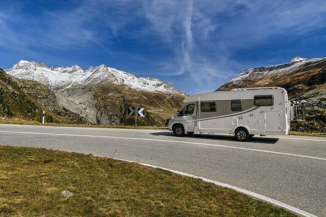 Motorhome driving on Grimselpassstraße, Rhonequelle in the background, Uri Alps, Valais, Switzerland