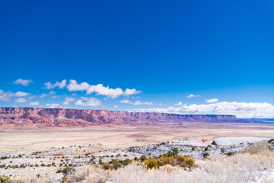 The Vermilion Cliffs National Monument seen on the horizon of the Arizona desert.