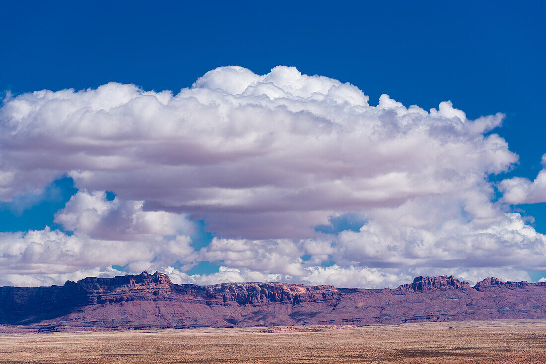 The Vermilion cliffs in Arizona under a cloudy sky.