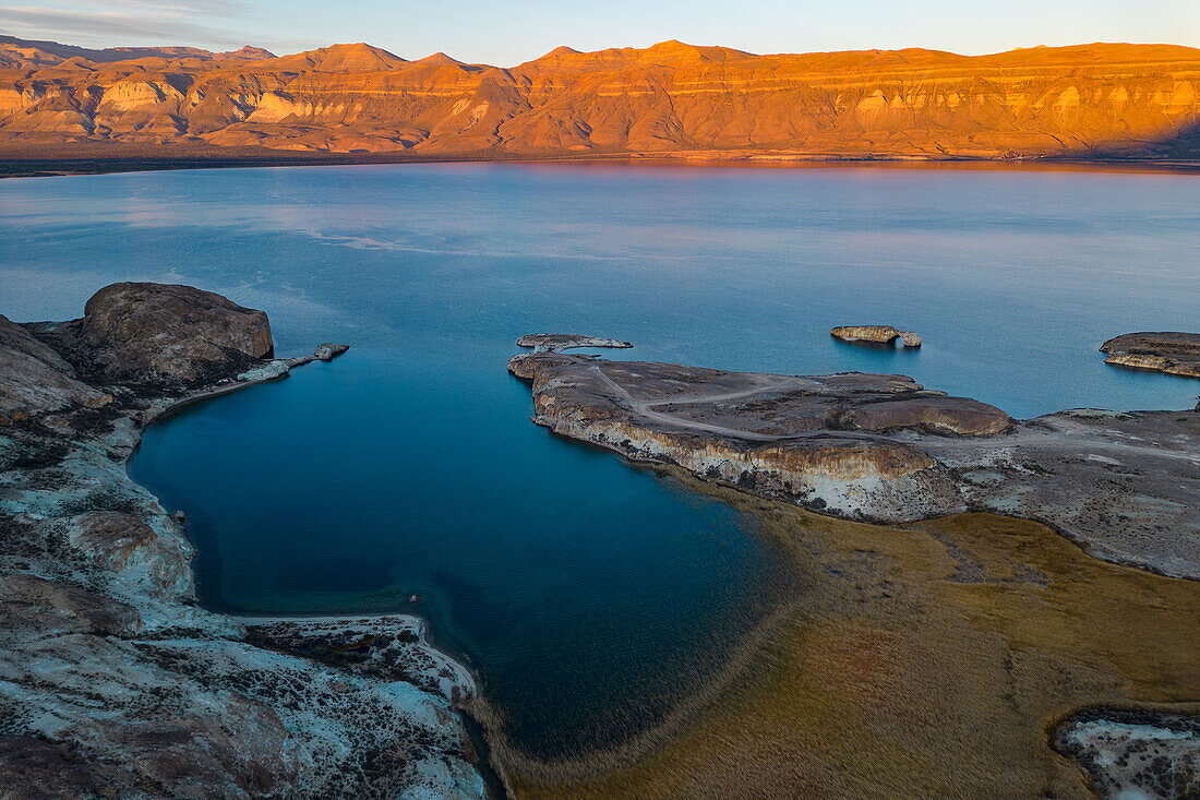 Aerial view showing the distinctive and remote Arco de Piedra in front of a bay at sunrise near the Chilean border, Lago Posadas, Argentina, Patagonia