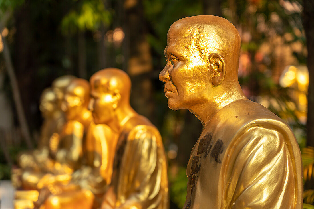 Golden statues of monks in the Buddhist temple complex of Wat Phra Singh, Chiang Mai, Thailand, Asia