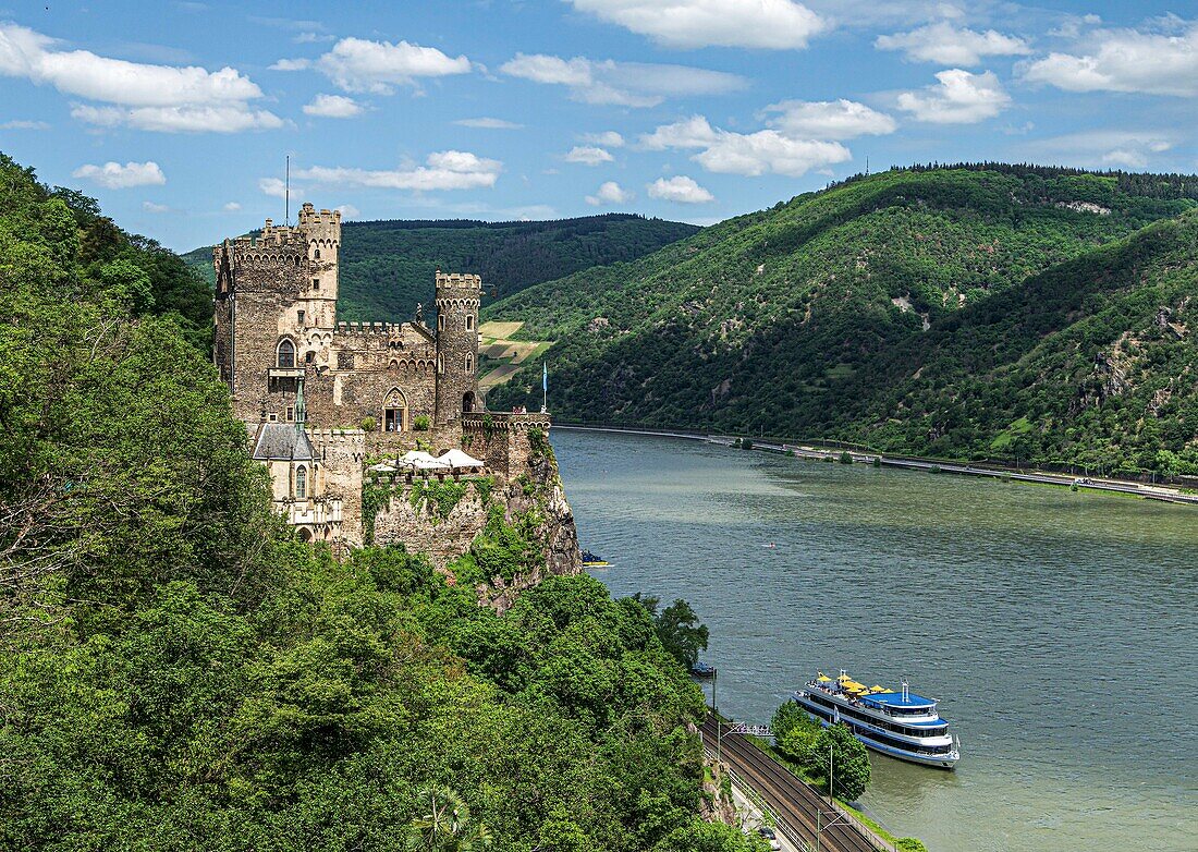 Panorama of Rheinstein Castle with tourist ship at Landungsbrücke, Trechtingshausen, Upper Middle Rhine Valley, Rhineland-Palatinate, Germany