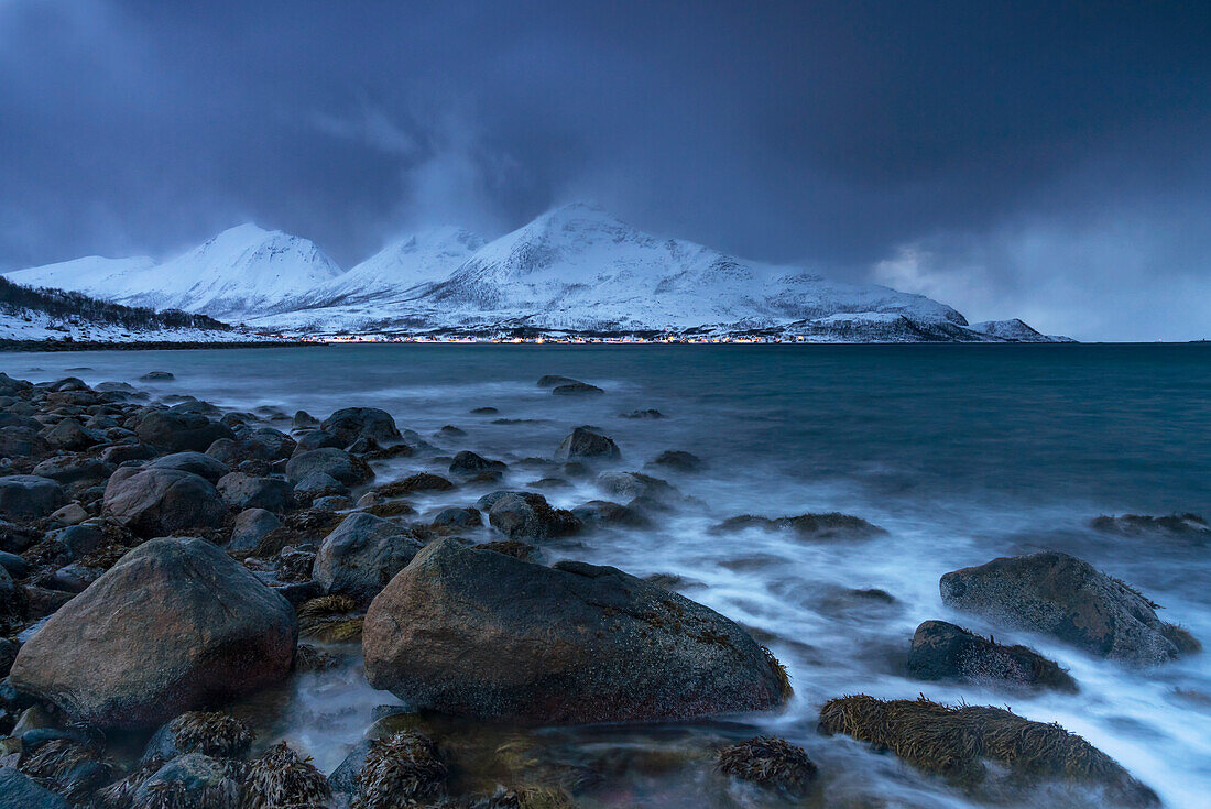 Wintry coastal landscape in the Norwegian Sea near Tromvik, Norway.
