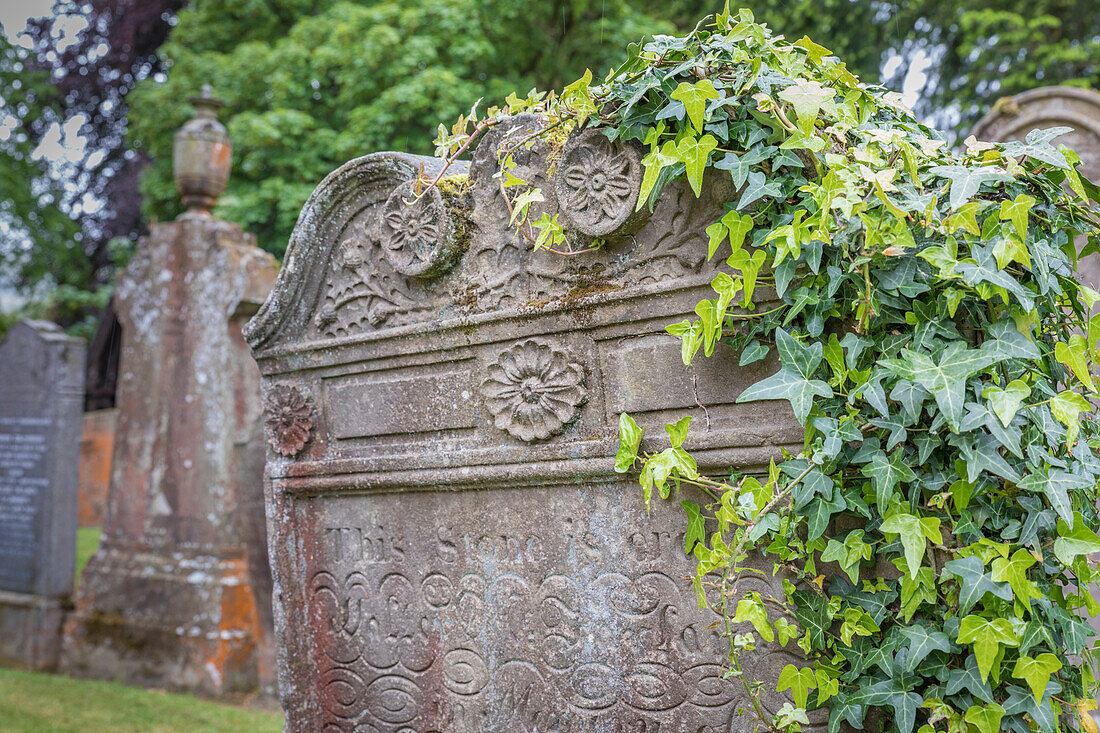 Old headstones in the churchyard in the village of Luss, Loch Lomand, Argyll and Bute, Scotland, UK