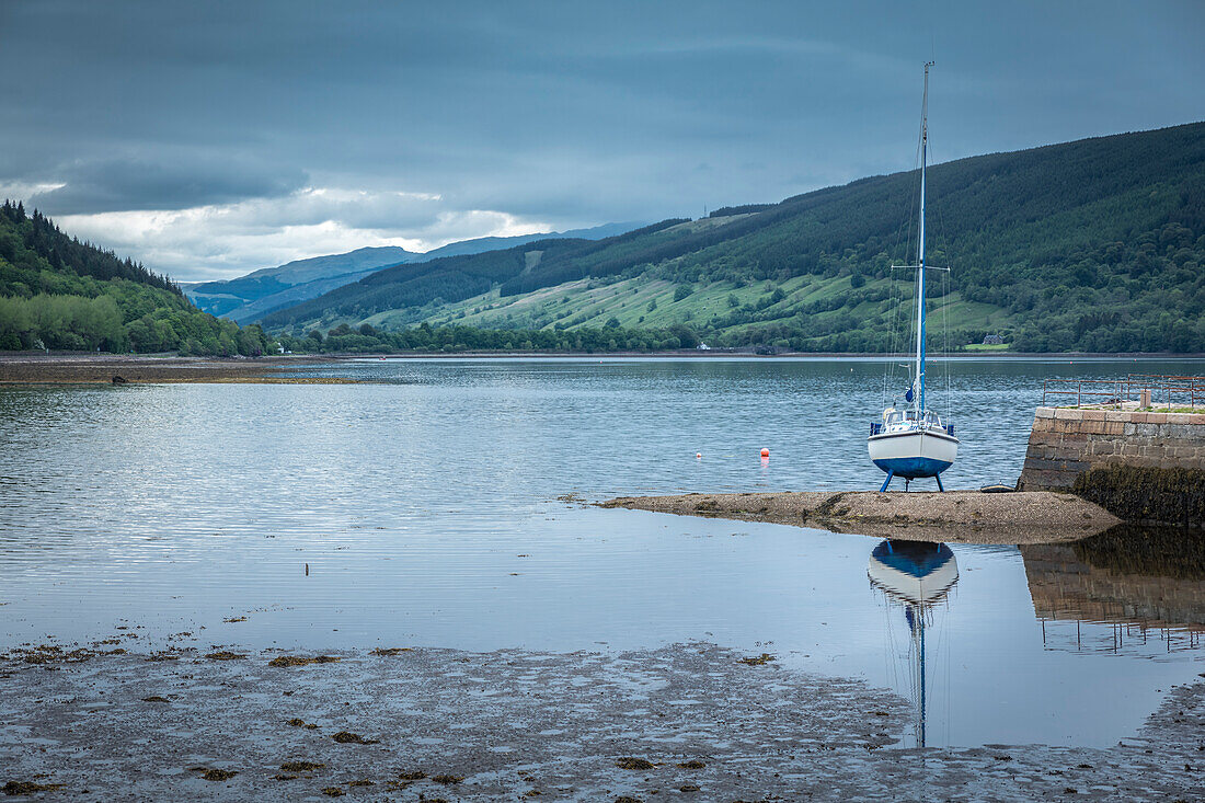 Sailing boat at low tide in Inveraray Harbour, Argyll and Bute, Scotland, UK