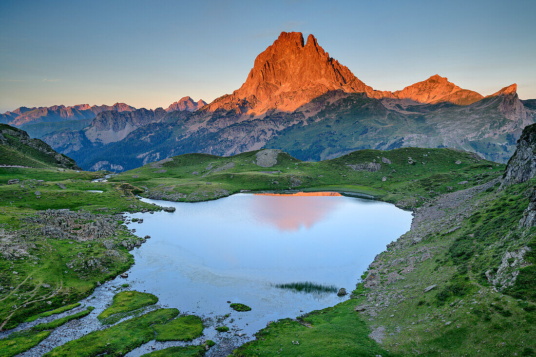 Alpenglow at Pic du Midi with mountain lake in foreground, Vallee d'39; Ossau, Pyrenees National Park, Pyrenees, France