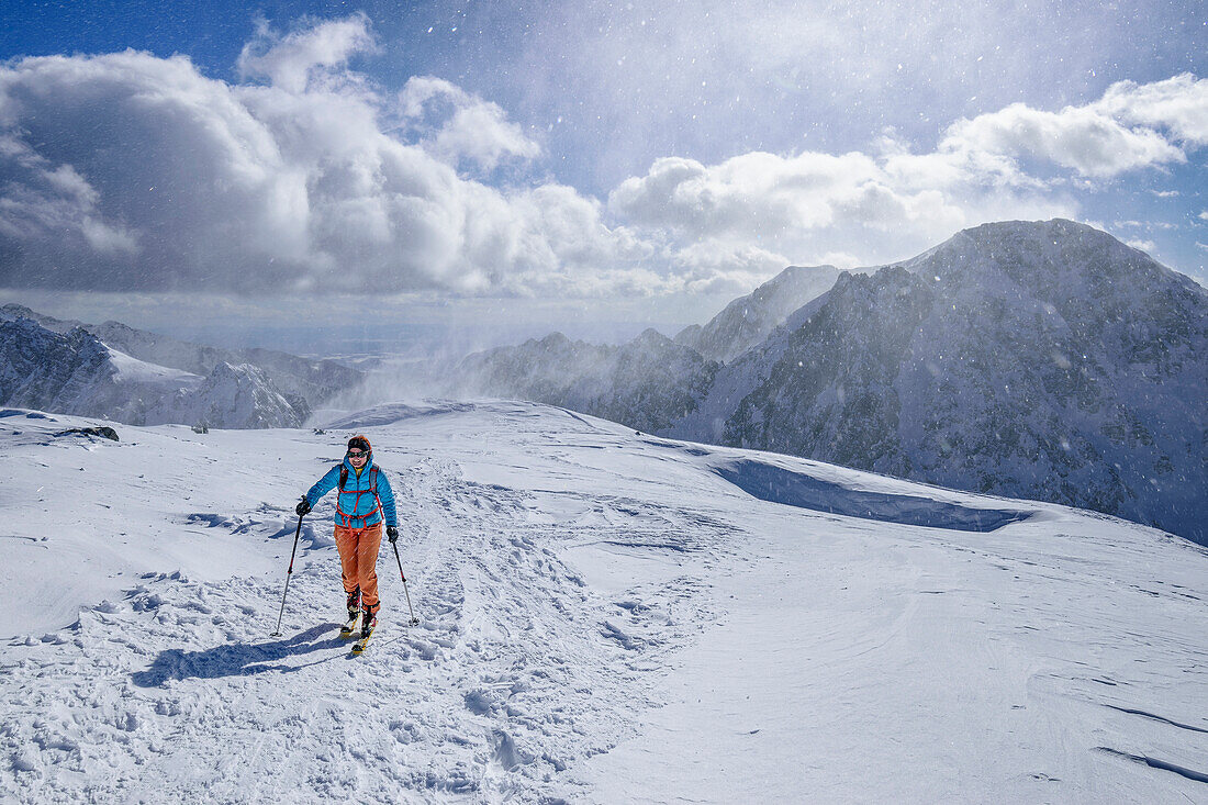 Woman on ski tour ascending to Kosiak through snowstorm, Kosiak, Rosental, Karawanken, Carinthia, Austria