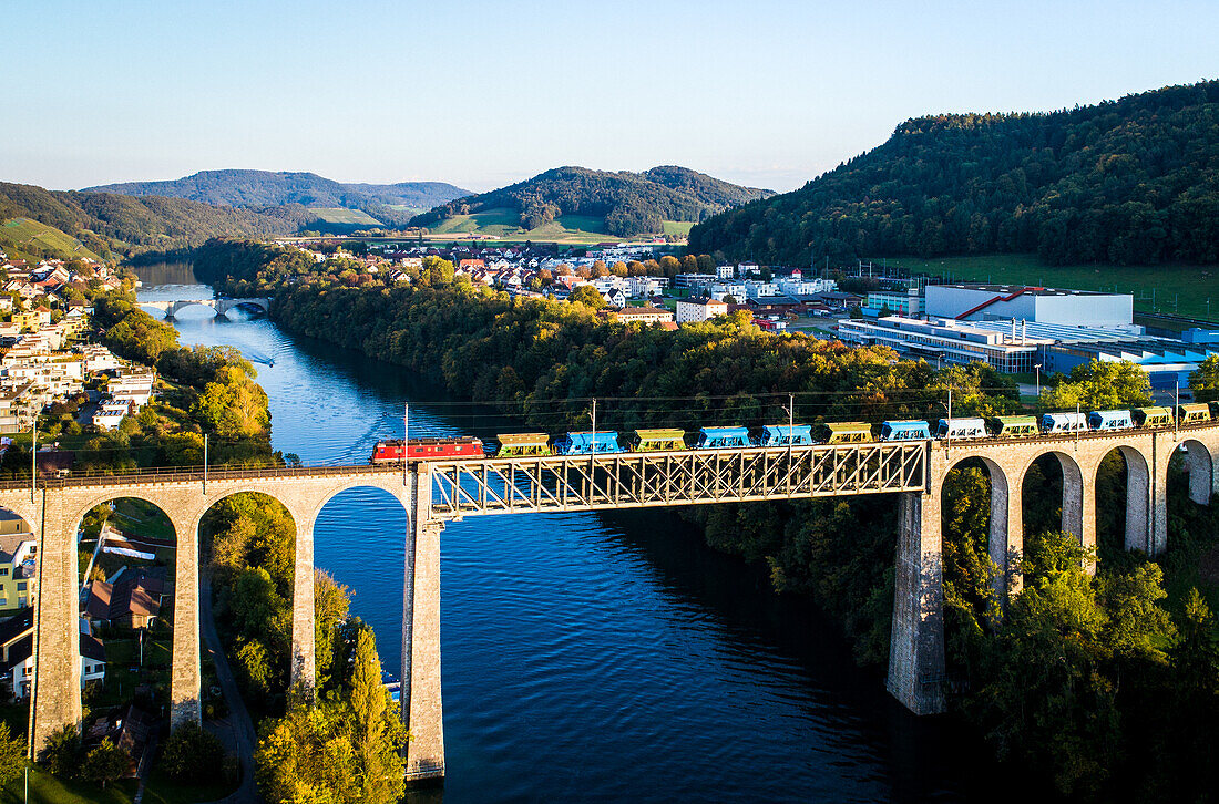 Red, Green & Blue Train, Freight train on bridge over River Rhein, Eglisau, Switzerland