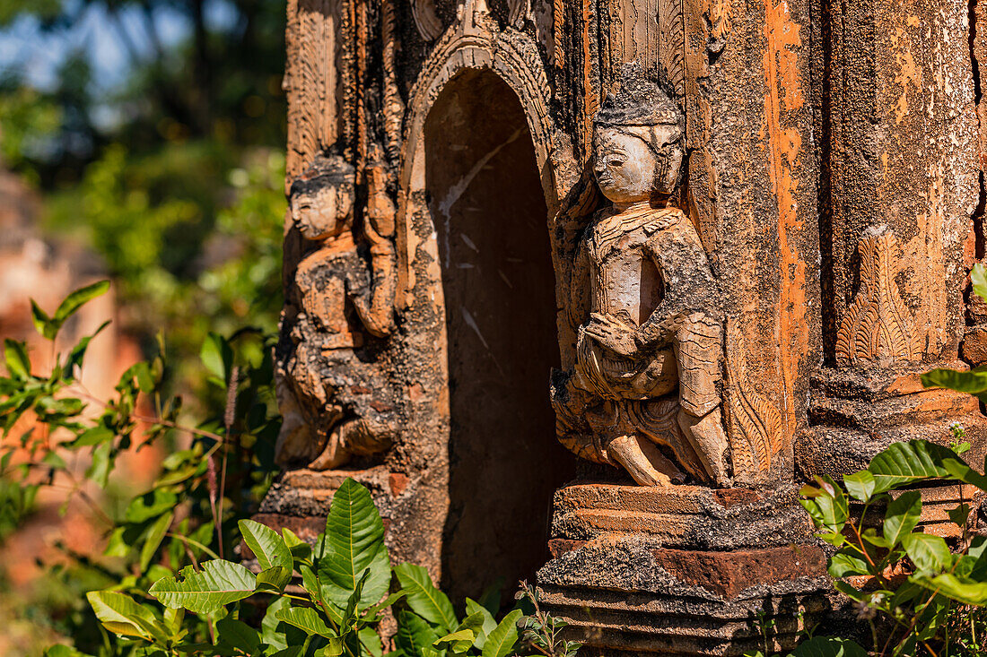 Two impressive sculptures at the entrance of an ancient stupa in the In-Dein Buddhist Cemetery on Inle Lake in Myanmar, Southeast Asia