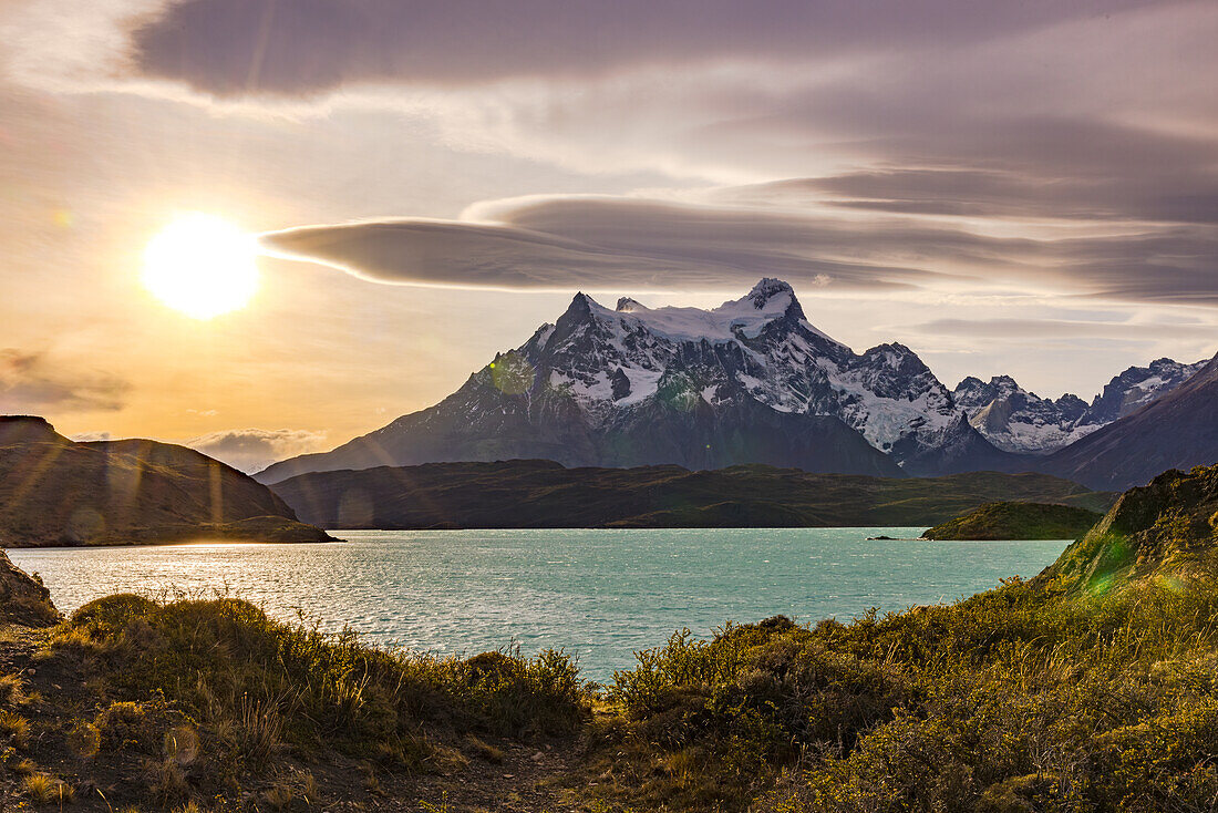 Gentle evening mood with sun and lake in front of the main mountain Cerro Paine Grande of the Torres del Pains massif, Chile, Patagonia, South America