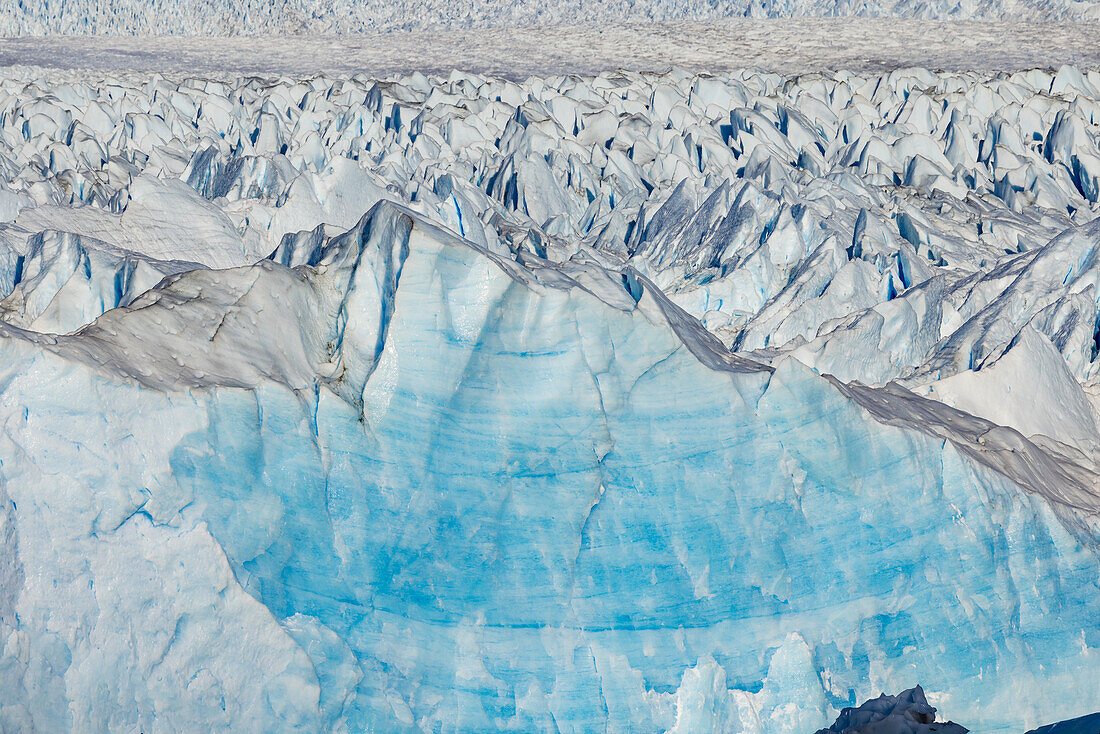 Light blue ice and ice crevices at the edge of Perito Moreno Glacier at Lago Argentino, Los Glaciares National Park, Argentina, Patagonia, South America