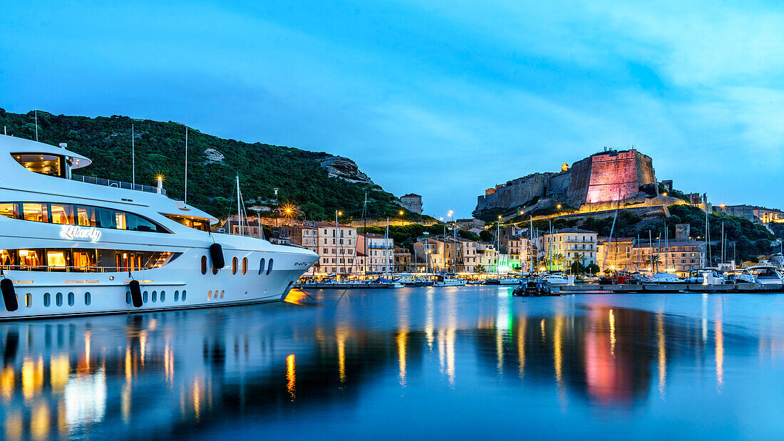 Port of Bonifacio, citadel, blue hour, luxury yacht Liberty, 57m, sailing under the flag of the Cayman Islands, Corsica, France, Europe