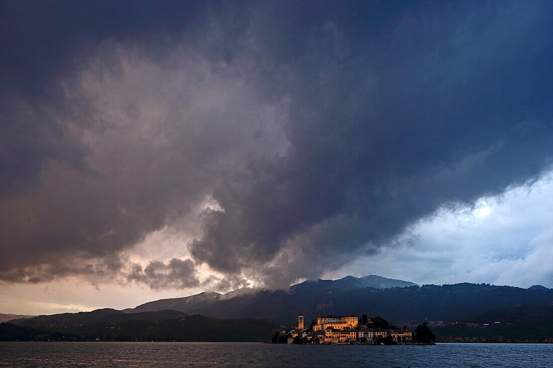 Thunderstorm over Isola San Giulio in Lake Orta with Basilica di San Giulio and Abbey Mater Ecclesiae, Piedmont, Italy