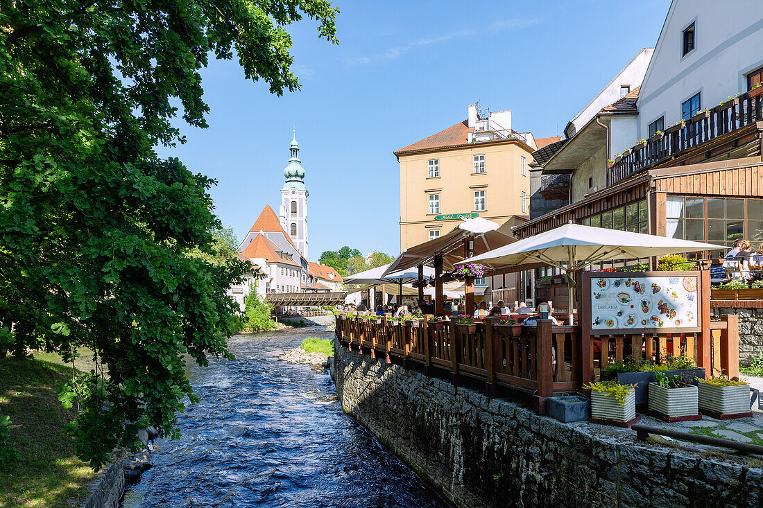Vltava arm with a view of the Church of St. Jobst and the Leylaria restaurant in Český Krumlov in southern Bohemia in the Czech Republic