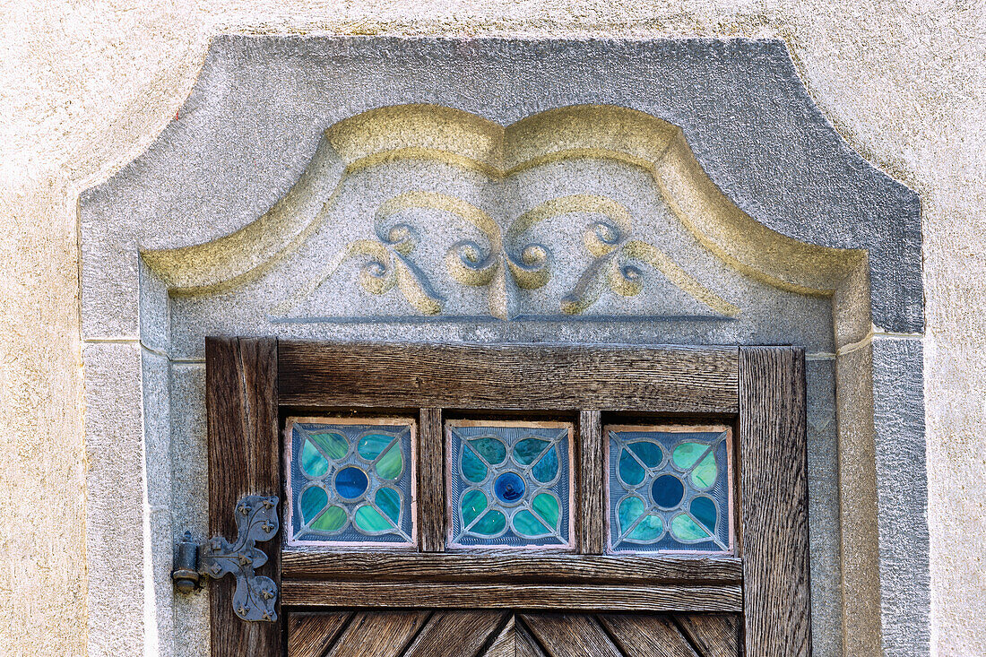 Side portal of the Church of the Assumption with glass bricks in Art Nouveau style in Rožmitál na Šumavě in South Bohemia in the Czech Republic