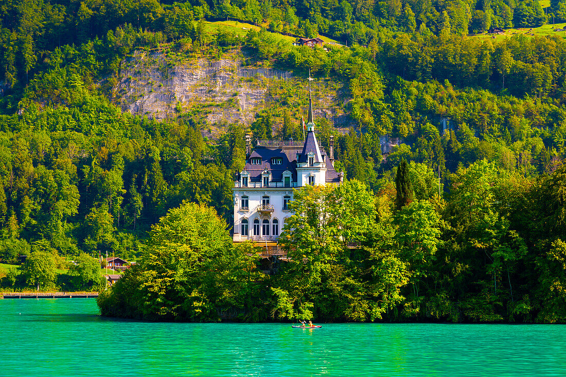 Castle in Iseltwald and Mountain on Lake Brienz in a Sunny Day in Interlaken, Bern Canton, Switzerland.