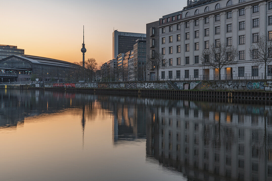 Sunrise over the Spree and the television tower in Berlin, Germany.