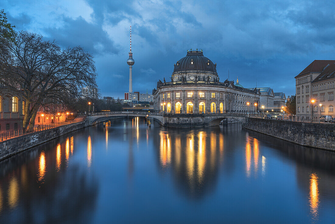At the blue hour at the Bode Museum with a view of the television tower in Berlin, Germany.