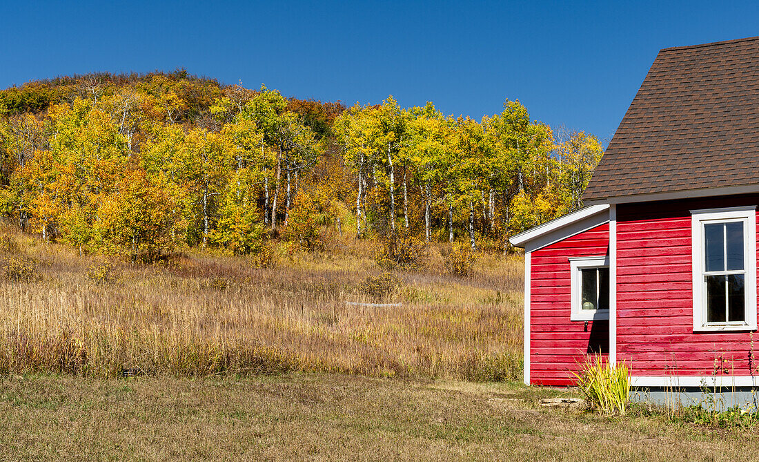 Little red schoolhouse in Hinton Gulch with fall foliage.