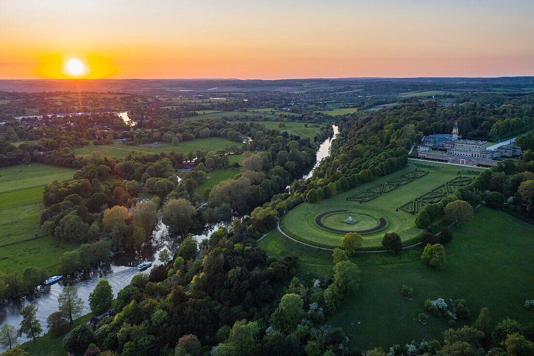 Aerial view of a Le Boat Horizon 4 houseboat on the River Thames with the Cliveden National Trust at sunset, near Maidenhead, Berkshire, England, United Kingdom