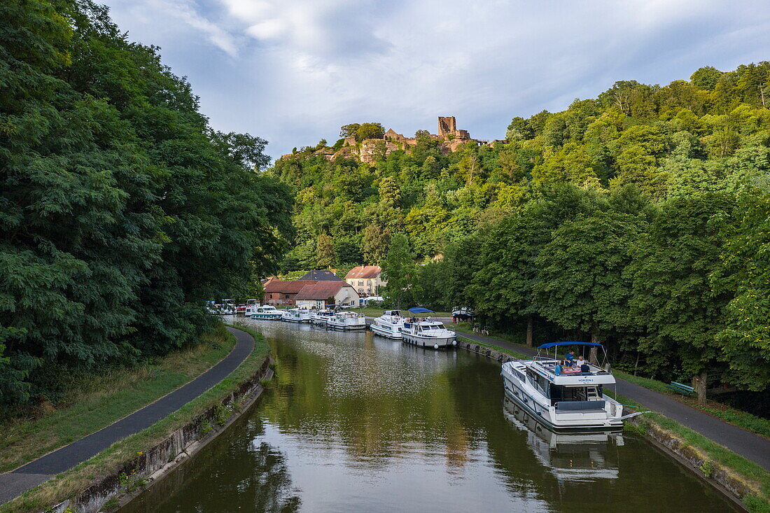 Aerial view of houseboats on the Canal de la Marne au Rhin with Château de Lutzelbourg castle, Lutzelbourg, Moselle, France