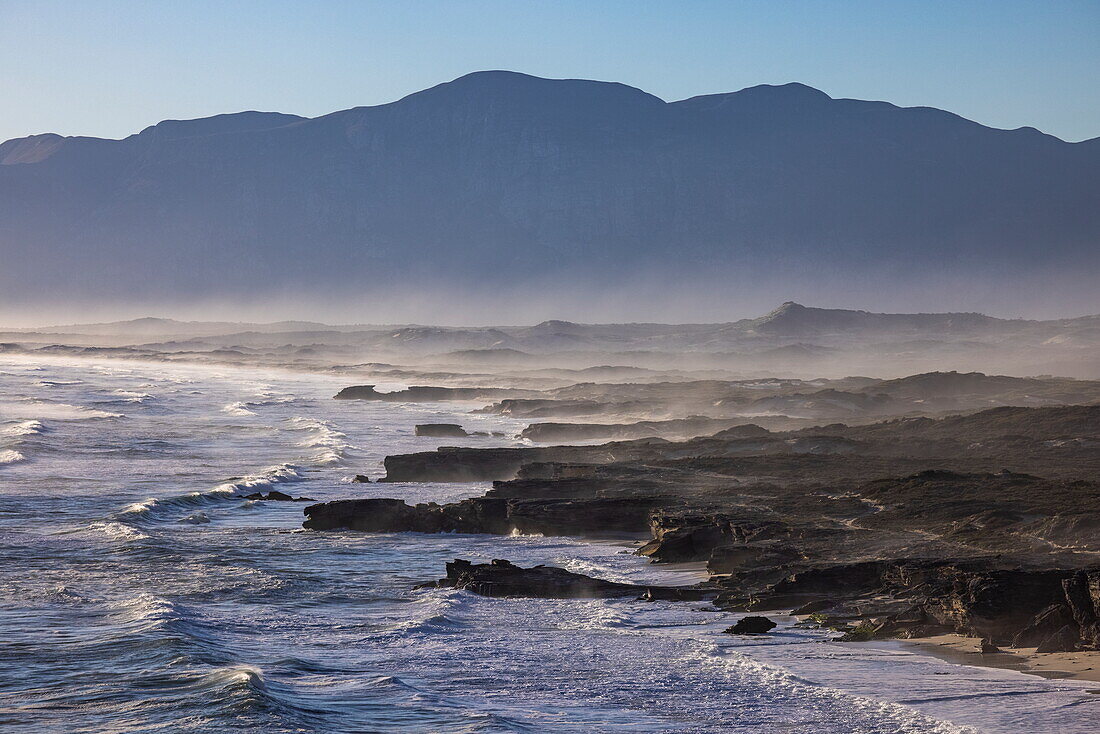 Waves breaking on rocky coast and beach at Walker Bay Nature Reserve, Gansbaai De Kelders, Western Cape, South Africa