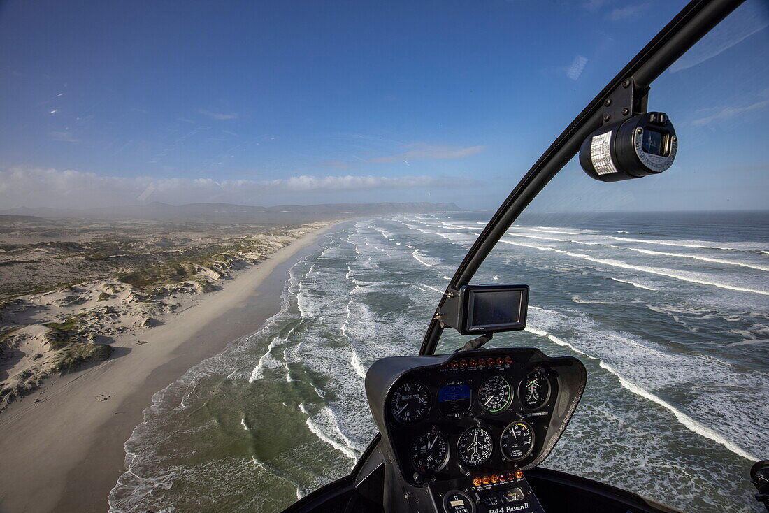 Aerial view through the windscreen of a helicopter over the coast and beach at Walker Bay Nature Reserve, Gansbaai De Kelders, Western Cape, South Africa