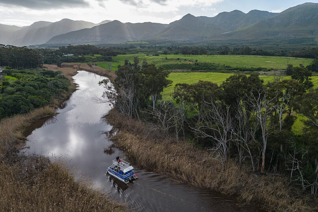 Aerial view from a tour boat on the Kleinrivier River with the mountains of Maanschynkop Nature Reserve behind, Stanford, Western Cape, South Africa