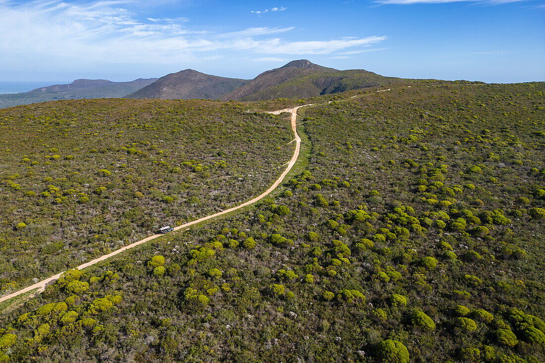 Aerial view of a Grootbos 4x4 safari vehicle on dirt road in the countryside, Grootbos Private Nature Reserve, Western Cape, South Africa
