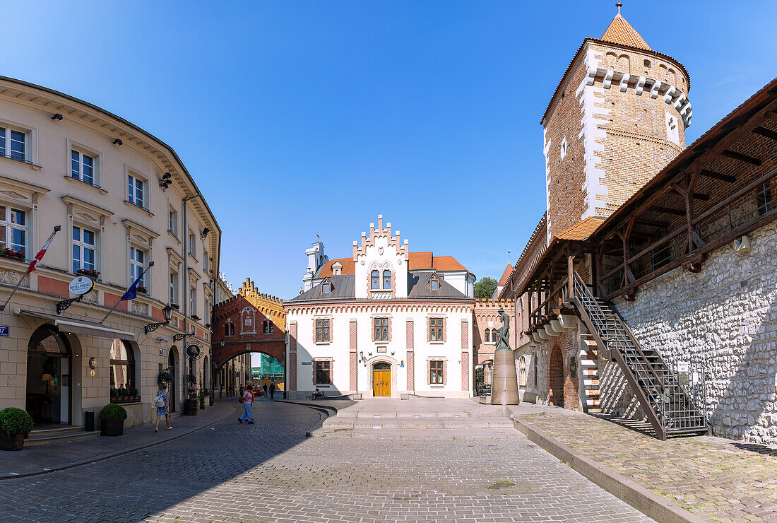 Pijarska Street with St. Florian's Gate (Brama Floriańska), city walls and Czartoryski Museum (Klasztorek Muzeum Książąt Czartoryskich) in the Old Town of Kraków in Poland