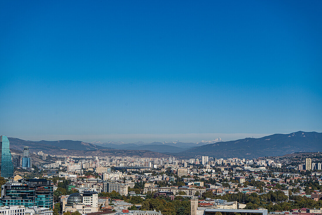 View of Tbilisi city and mount Kazbegi on the skyline covered with snow