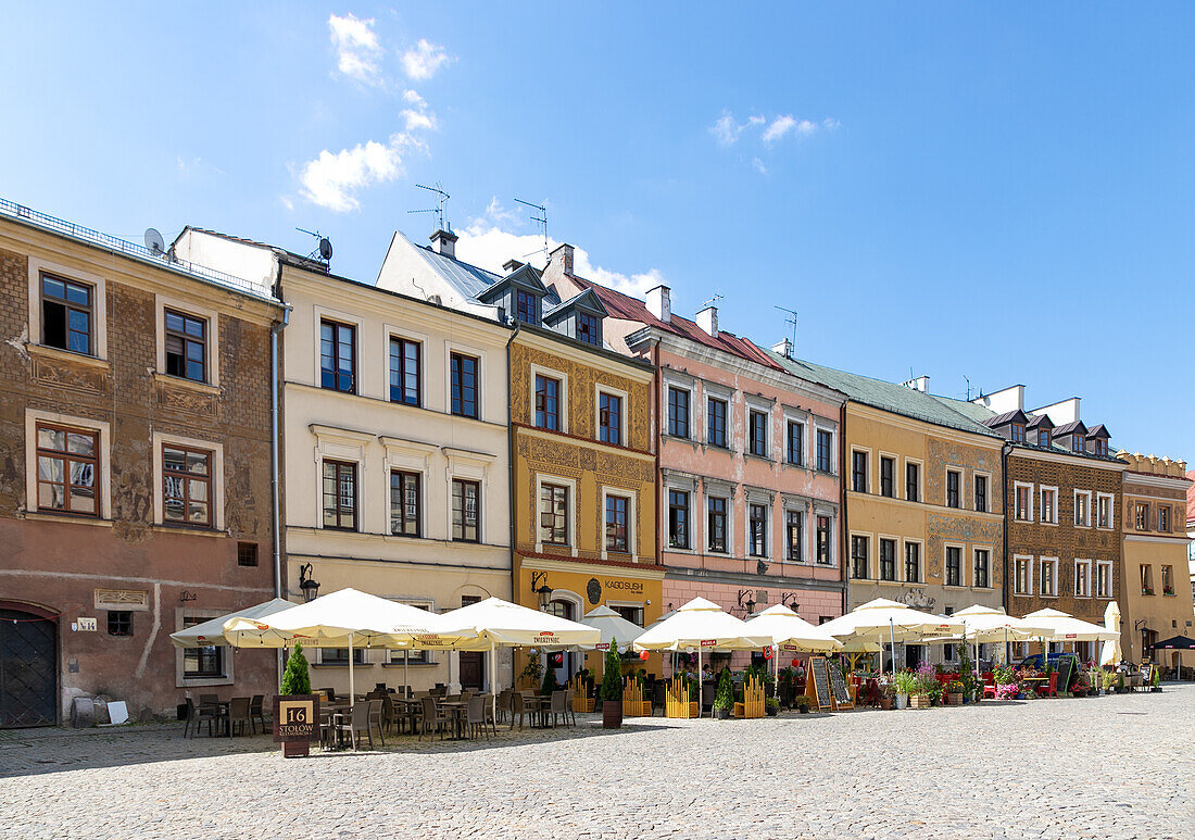 Rynek, south side and town houses with facade paintings and street cafes in Lublin in the Lubelskie Voivodeship in Poland