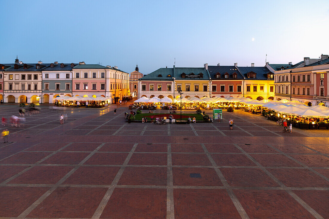 Rynek Wielki with street cafes and restaurants in the evening light in Zamość in Lubelskie Voivodeship of Poland